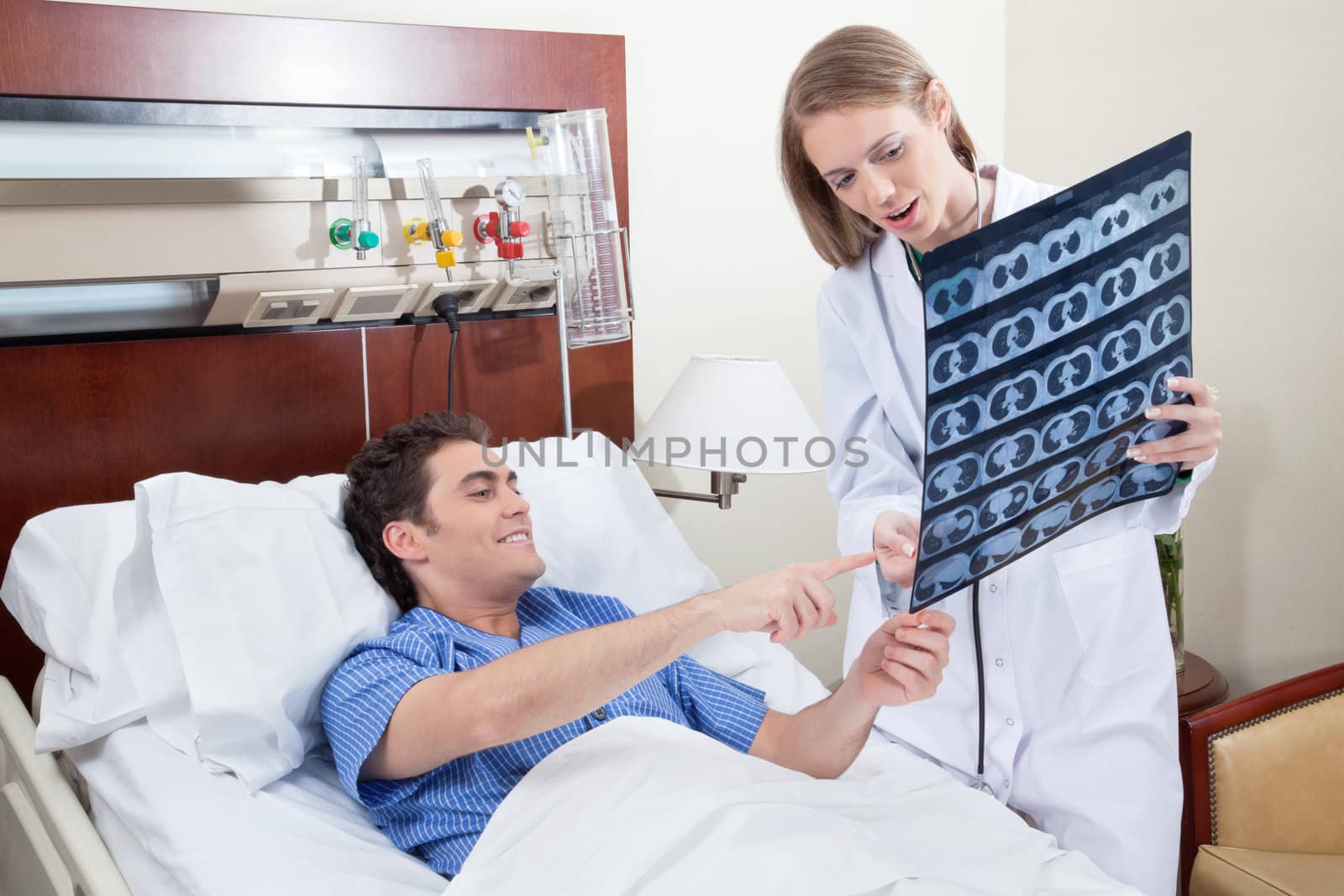 Doctor showing X-ray report to the smiling patient