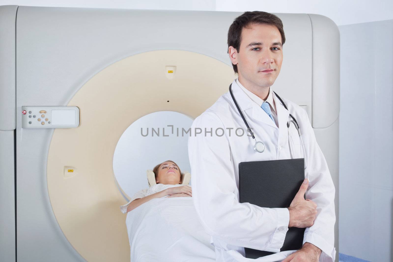 Doctor with stethoscope in front of MRI scan machine