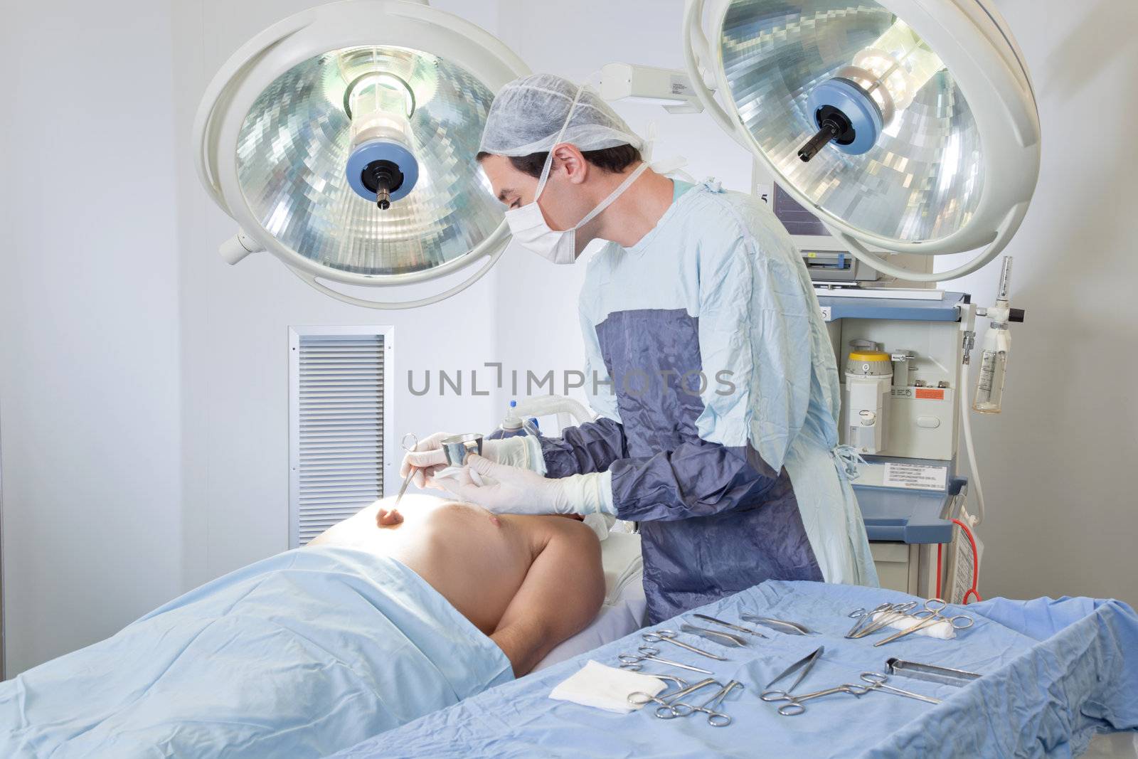 Doctor performing operation on patient in operating room