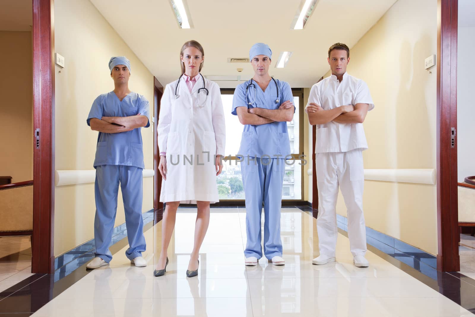 Team of doctor and nurse standing in hallway of hospital