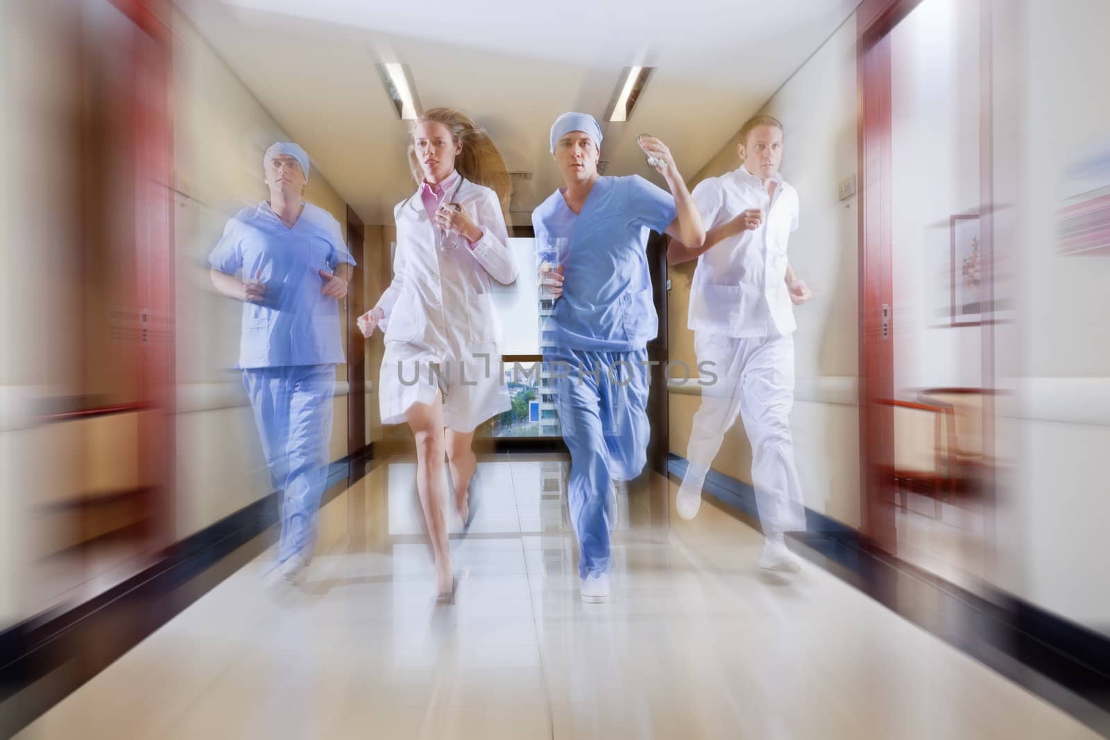 Surgeon and nurse running in hallway of hospital