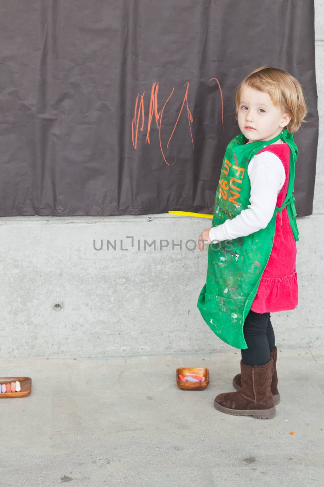 Cute little baby girl having fun painting at art class