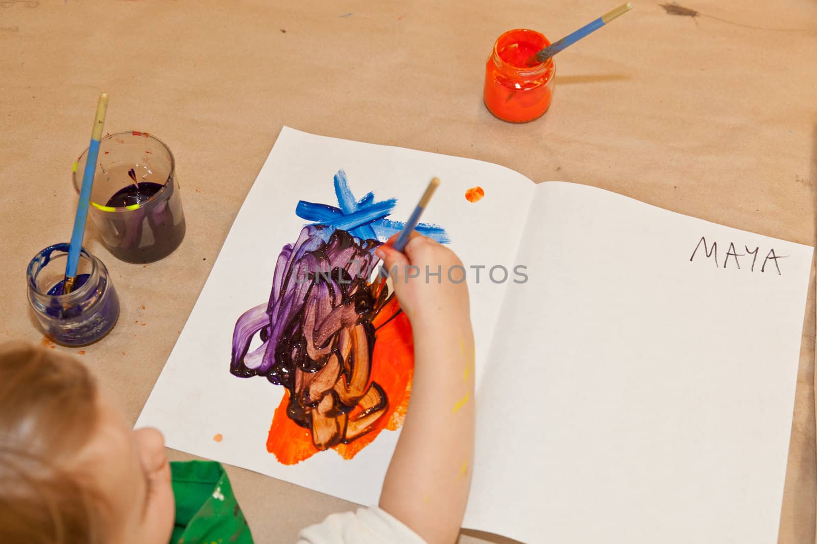 Cute little baby girl having fun painting at art class