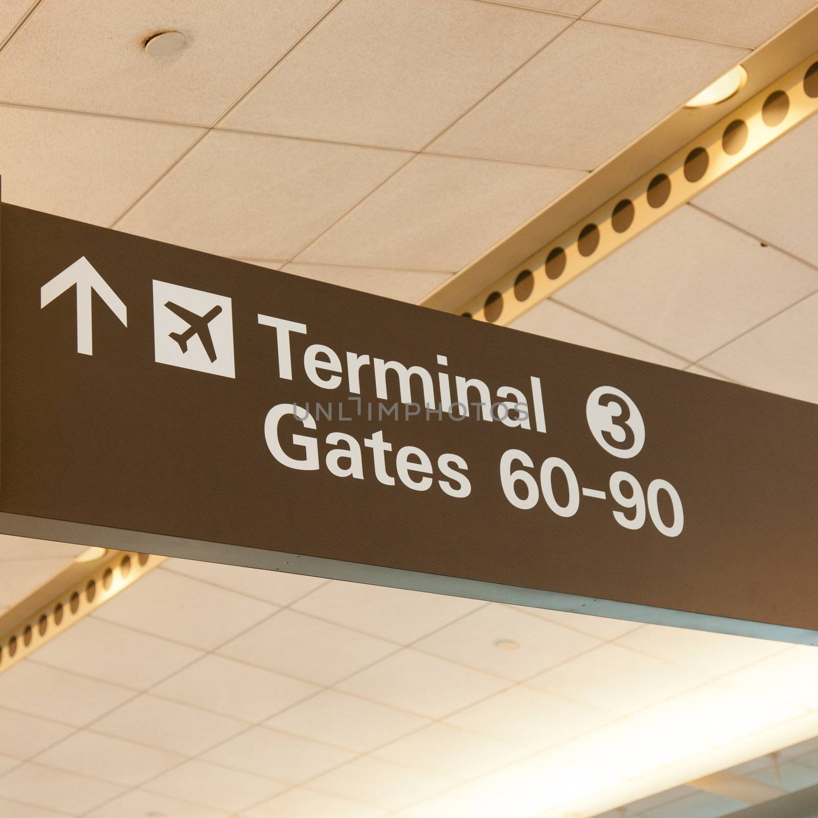 Informational sign showing gate numbers at international airport.