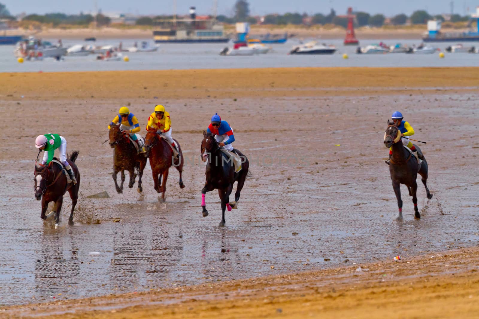 SANLUCAR DE BARRAMEDA, CADIZ, SPAIN - AUGUST 11: Unidentified riders of the accidented horses races of the beach of Sanlucar de Barrameda on August 11, 2011 in Sanlucar de Barrameda, Cadiz, Spain.