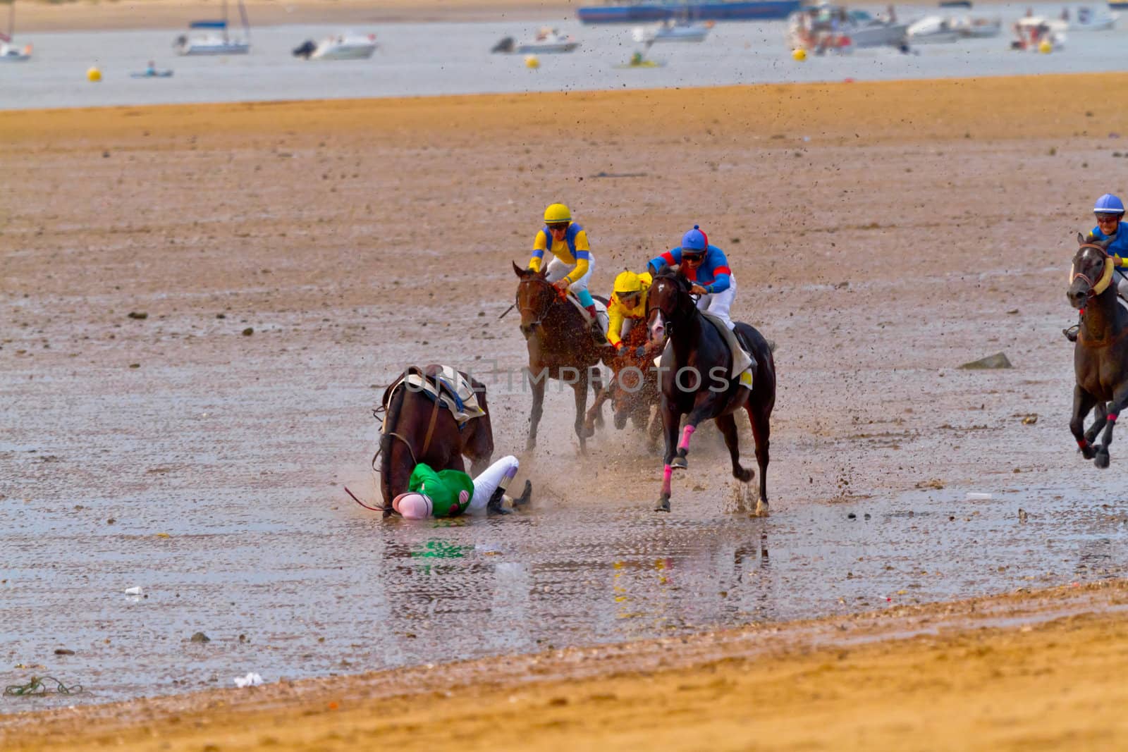 SANLUCAR DE BARRAMEDA, CADIZ, SPAIN - AUGUST 11: Unidentified riders race horses on Sanlucar de Barrameda beach on August 11, 2011 in Sanlucar de Barrameda, Cadiz, Spain.