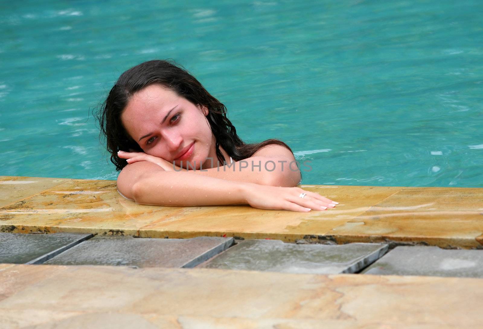 Beautiful woman enjoying summer in the pool