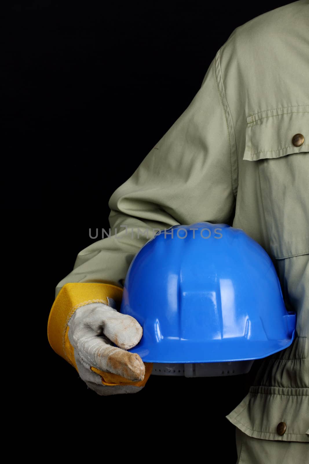 man holding blue helmet over black background 