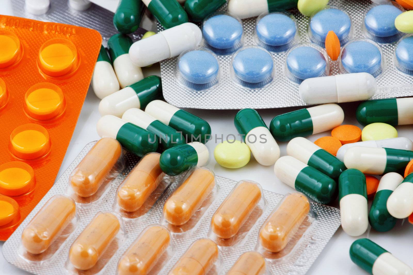 Pills of many shapes and colors grouped together