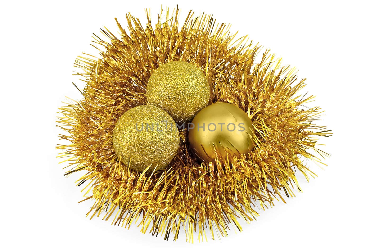 A nest of golden tinsel with three golden balls isolated on a white background