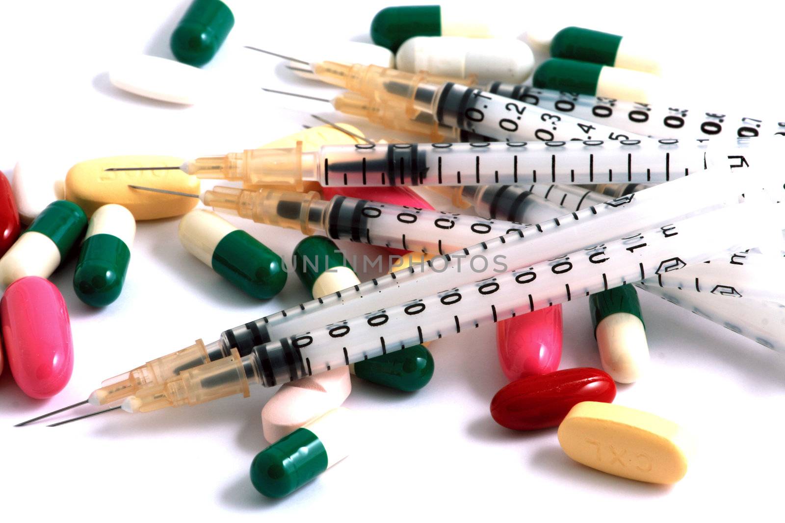 Pills of many shapes and colors grouped together