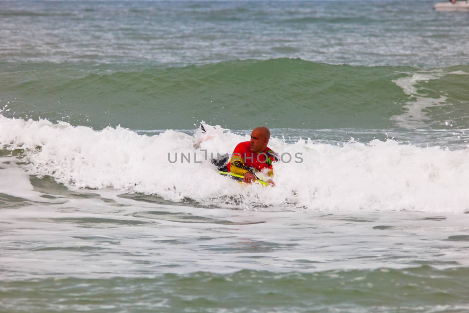 SAN FERNANDO, CADIZ, SPAIN - FEB 19: Unknown bodyboader going to the water on the 2nd championship of Surf and BodyBoard Impoxibol on Feb 19,2011 on the beach of Camposoto of San Fernando, Cadiz, Spain