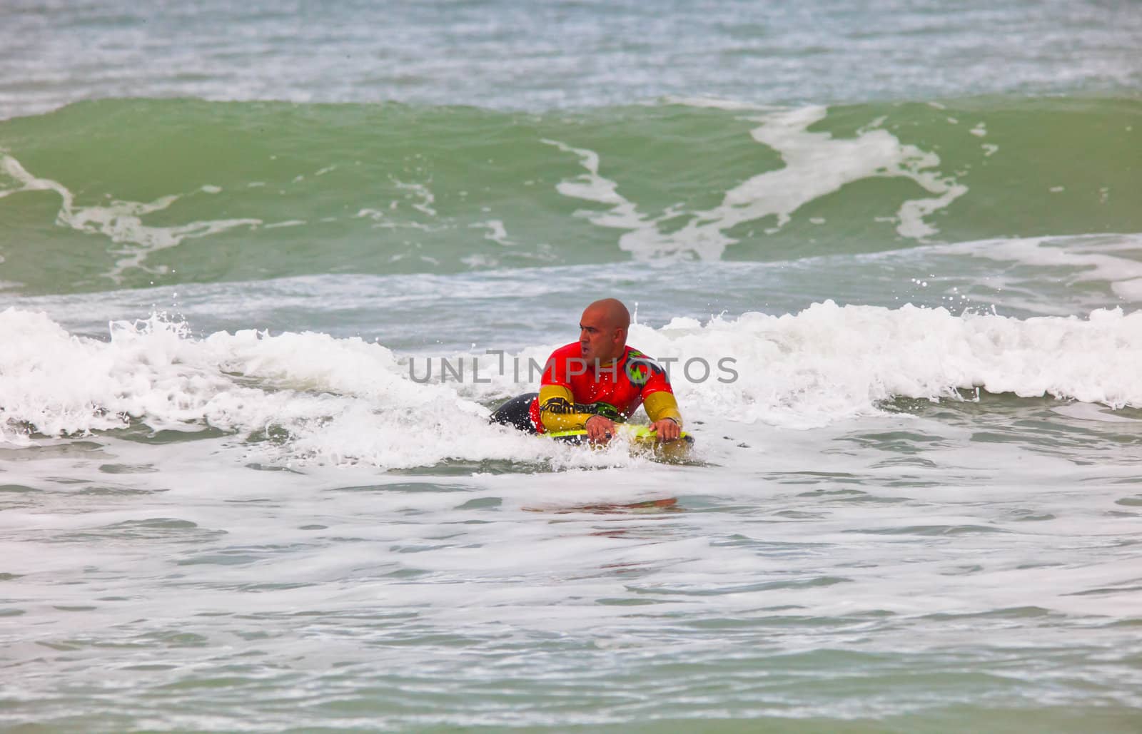 SAN FERNANDO, CADIZ, SPAIN - FEB 19: Unknown bodyboader going to the water on the 2nd championship of Surf and BodyBoard Impoxibol on Feb 19,2011 on the beach of Camposoto of San Fernando, Cadiz, Spain