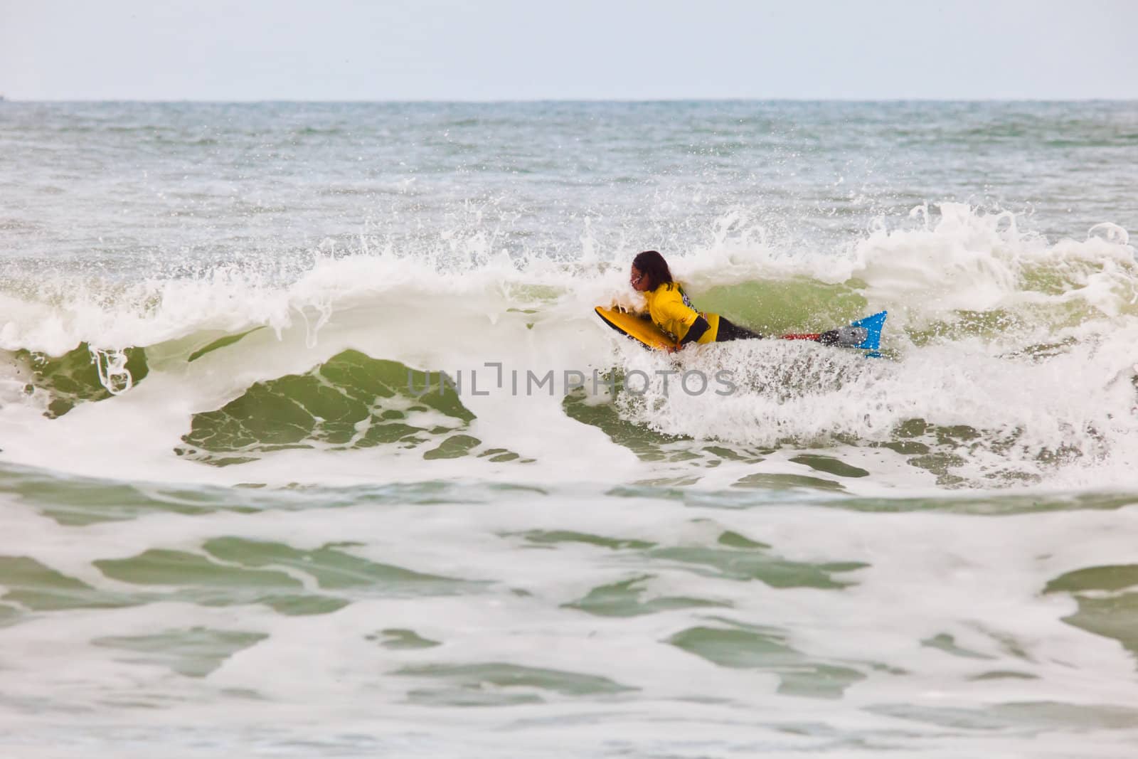 SAN FERNANDO, CADIZ, SPAIN - FEB 19: Unknown bodyboader going to the water on the 2nd championship of Surf and BodyBoard Impoxibol on Feb 19,2011 on the beach of Camposoto of San Fernando, Cadiz, Spain