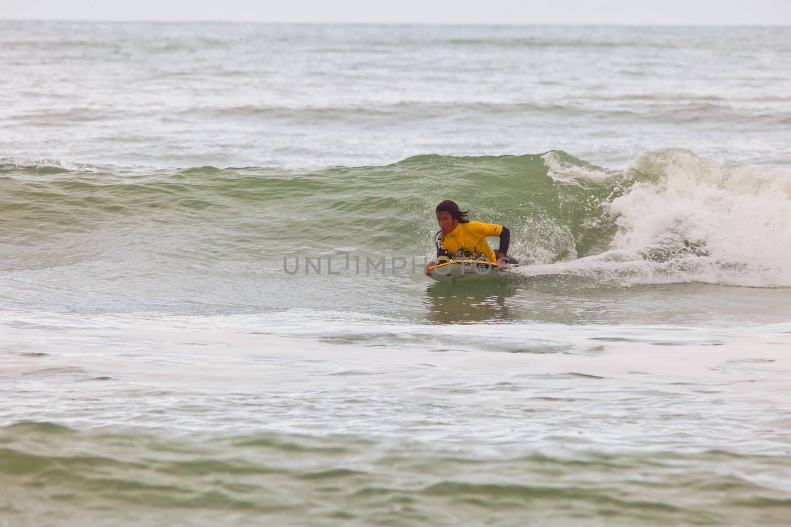 SAN FERNANDO, CADIZ, SPAIN - FEB 19: Unknown bodyboader going to the water on the 2nd championship of Surf and BodyBoard Impoxibol on Feb 19,2011 on the beach of Camposoto of San Fernando, Cadiz, Spain