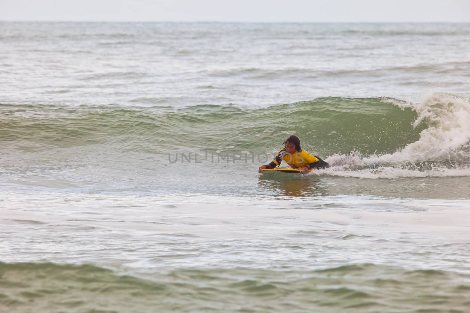 SAN FERNANDO, CADIZ, SPAIN - FEB 19: Unknown bodyboader going to the water on the 2nd championship of Surf and BodyBoard Impoxibol on Feb 19,2011 on the beach of Camposoto of San Fernando, Cadiz, Spain