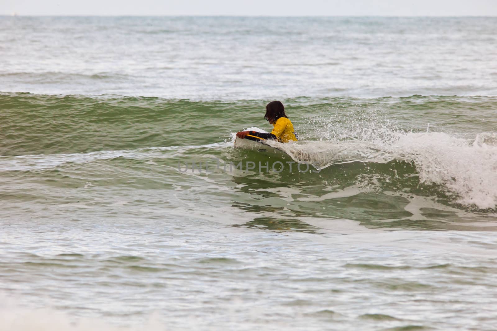 SAN FERNANDO, CADIZ, SPAIN - FEB 19: Unknown bodyboader going to the water on the 2nd championship of Surf and BodyBoard Impoxibol on Feb 19,2011 on the beach of Camposoto of San Fernando, Cadiz, Spain