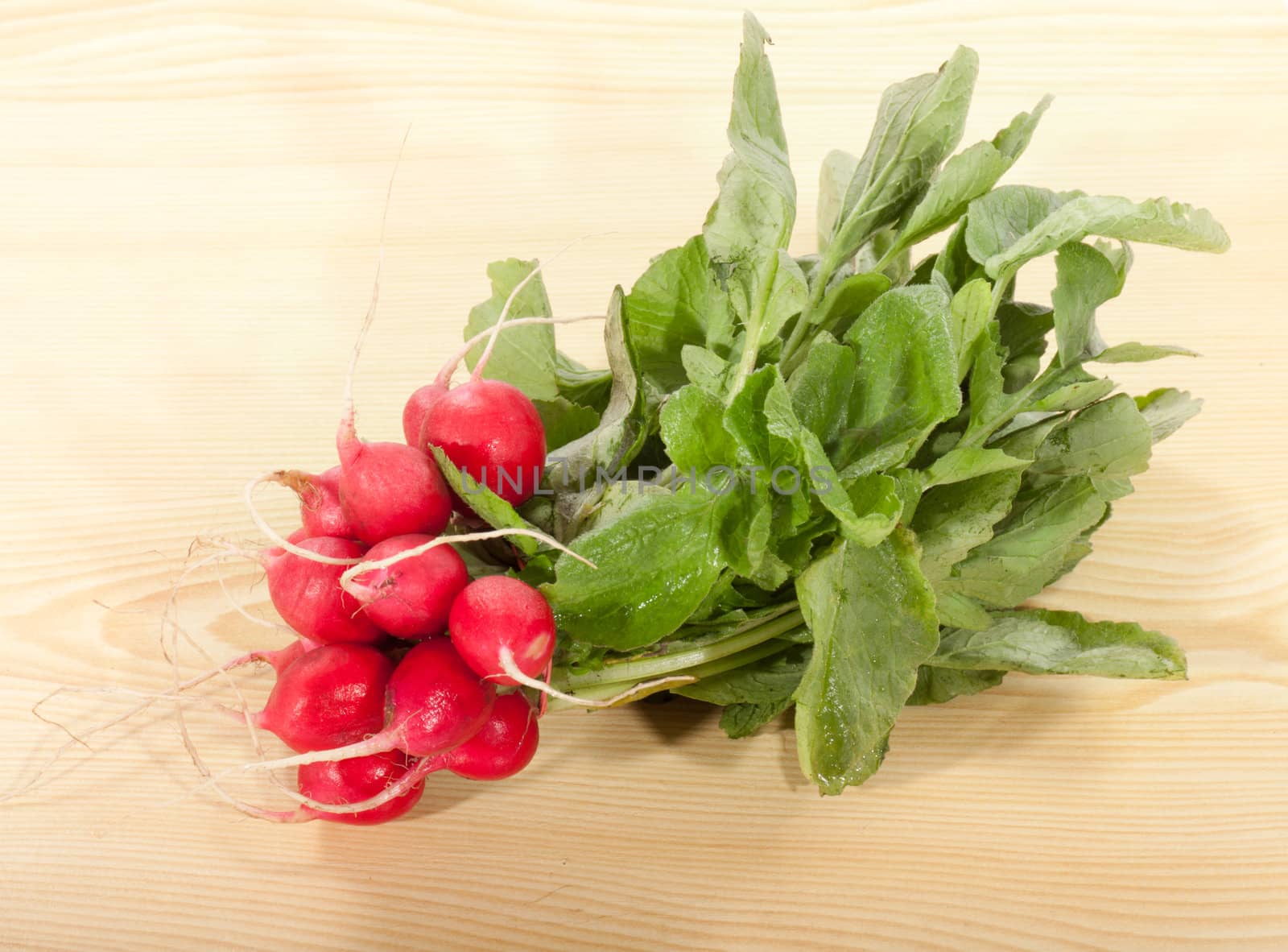 bunch of radishes on a wooden table