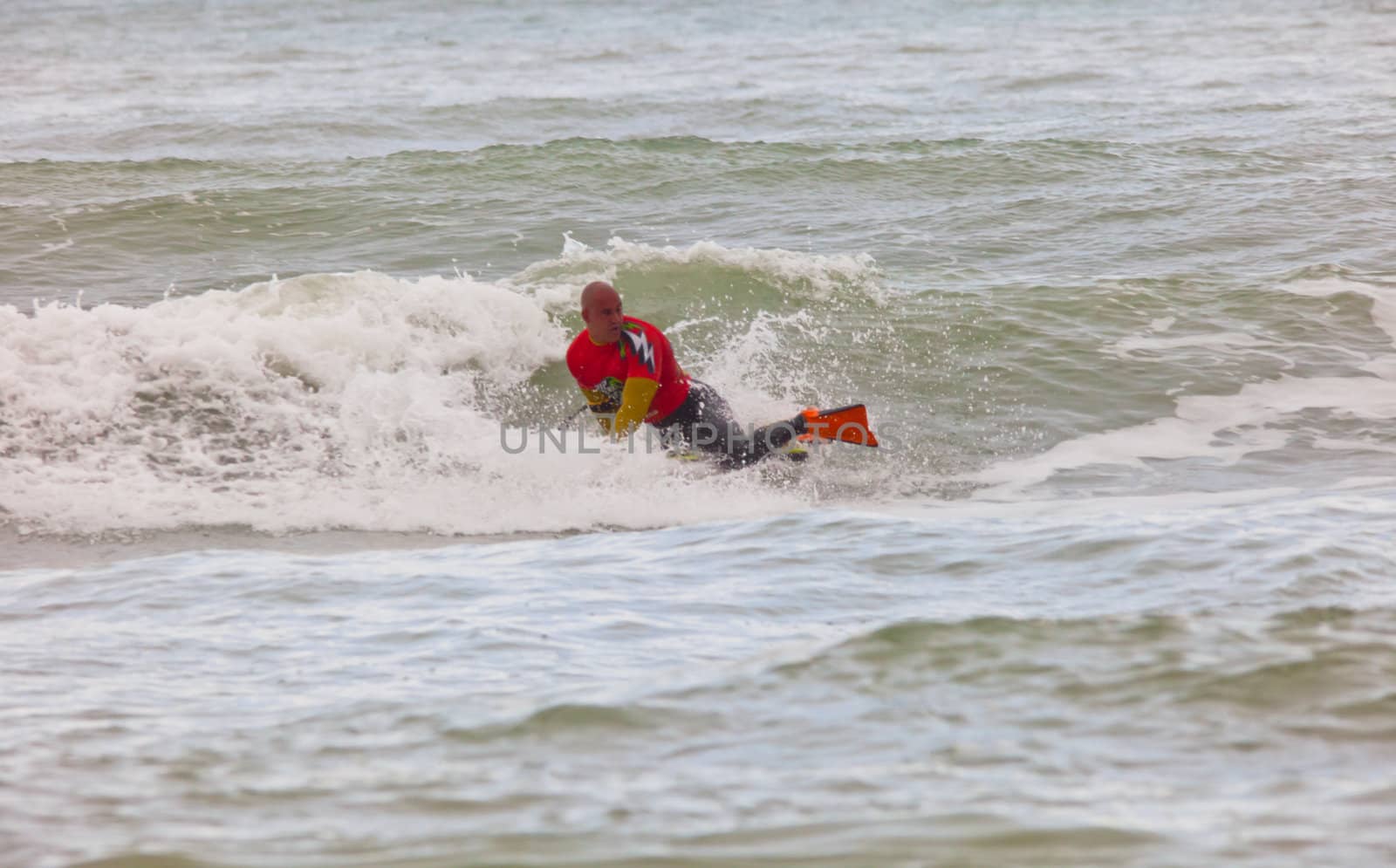 SAN FERNANDO, CADIZ, SPAIN - FEB 19: Unknown bodyboader going to the water on the 2nd championship of Surf and BodyBoard Impoxibol on Feb 19,2011 on the beach of Camposoto of San Fernando, Cadiz, Spain