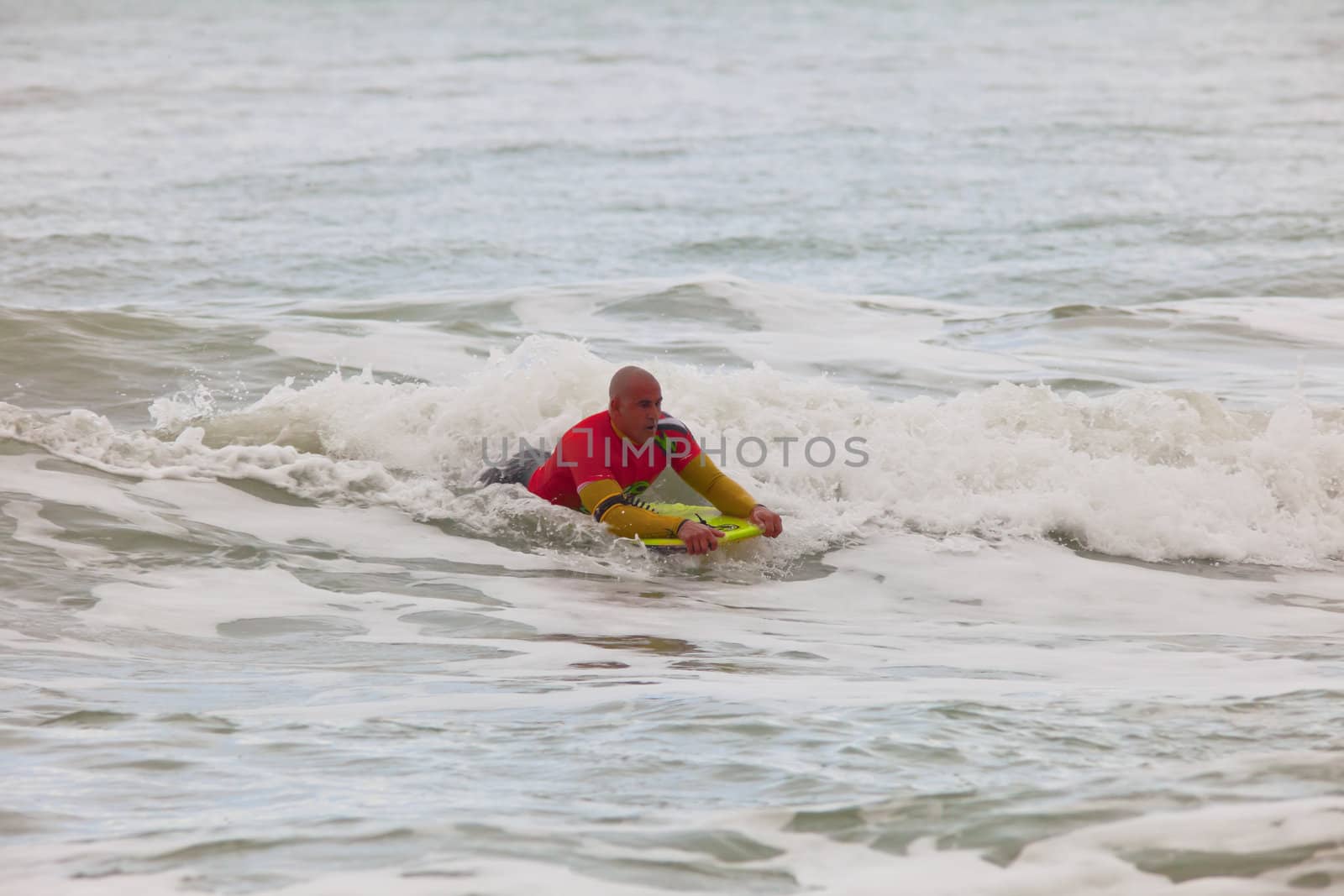 SAN FERNANDO, CADIZ, SPAIN - FEB 19: Unknown bodyboader going to the water on the 2nd championship of Surf and BodyBoard Impoxibol on Feb 19,2011 on the beach of Camposoto of San Fernando, Cadiz, Spain