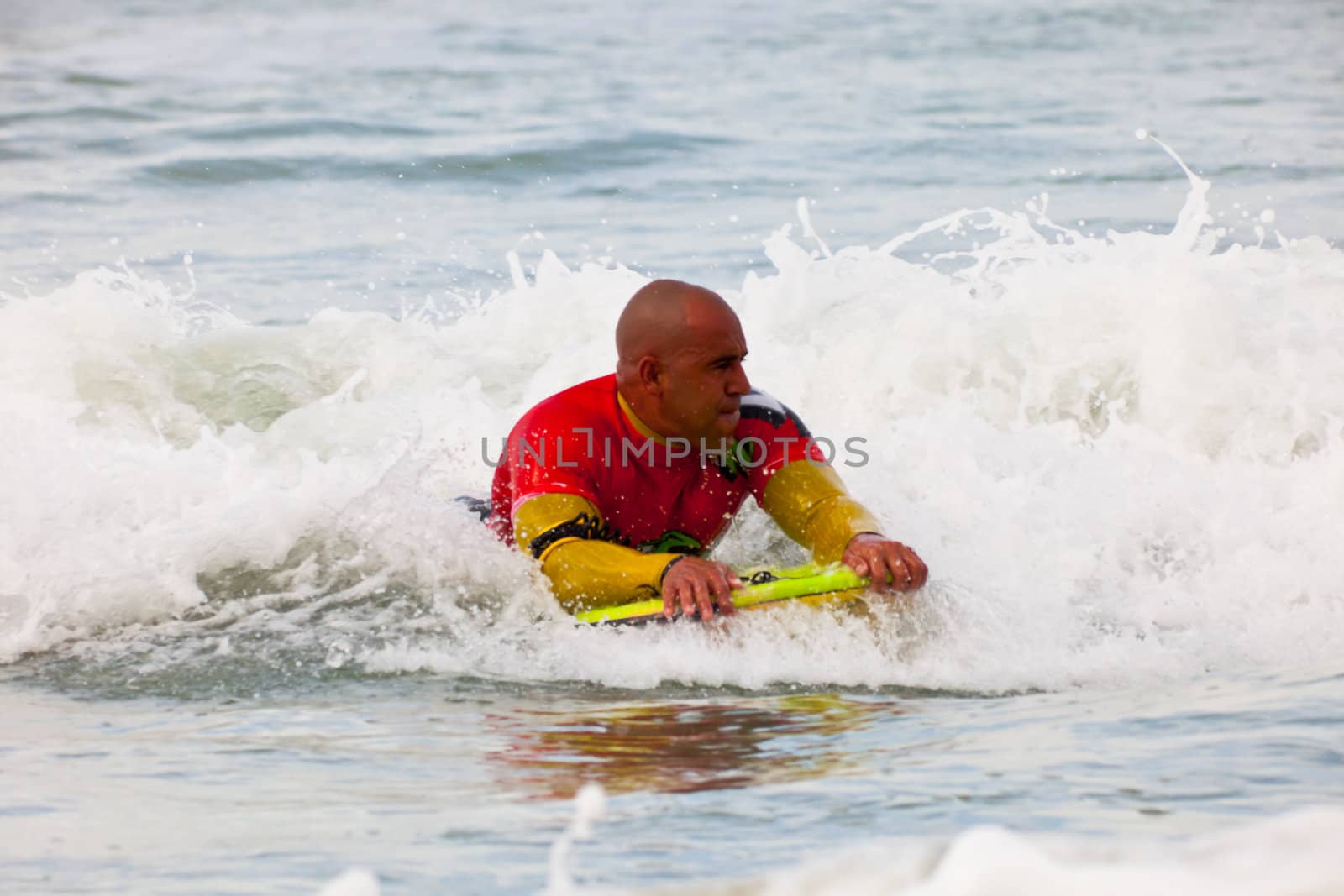SAN FERNANDO, CADIZ, SPAIN - FEB 19: Unknown bodyboader going to the water on the 2nd championship of Surf and BodyBoard Impoxibol on Feb 19,2011 on the beach of Camposoto of San Fernando, Cadiz, Spain