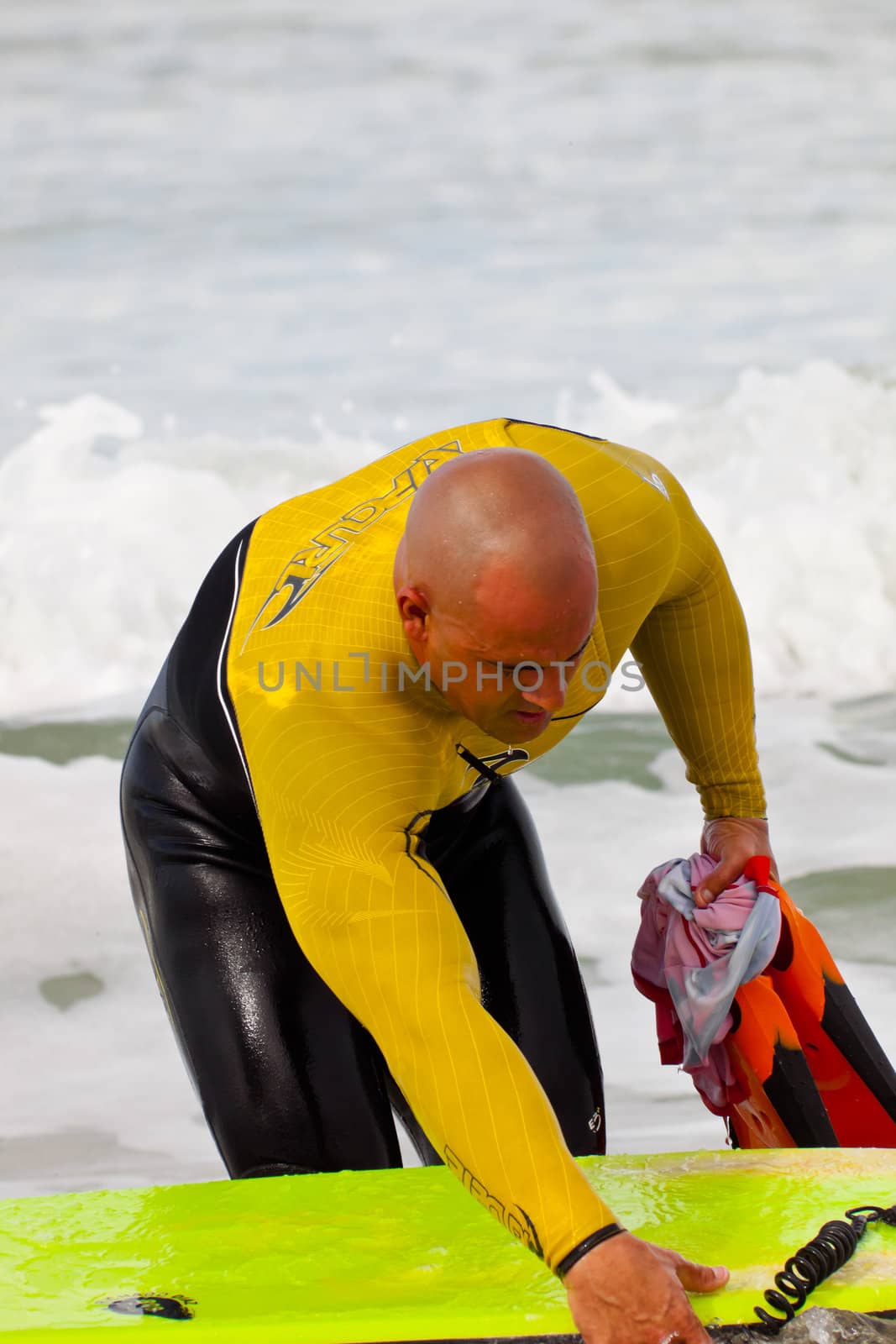 SAN FERNANDO, CADIZ, SPAIN - FEB 19: Unknown bodyboader going to the water on the 2nd championship of Surf and BodyBoard Impoxibol on Feb 19,2011 on the beach of Camposoto of San Fernando, Cadiz, Spain