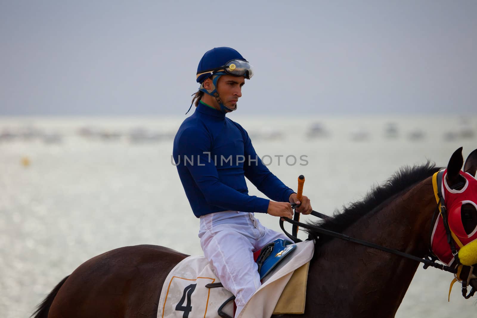 SANLUCAR DE BARRAMEDA, CADIZ, SPAIN - AUGUST 07: Unidentified riders at the start of race horses on Sanlucar de Barrameda beach on  August 07, 2010 in Sanlucar de Barrameda, Cadiz, Spain.
