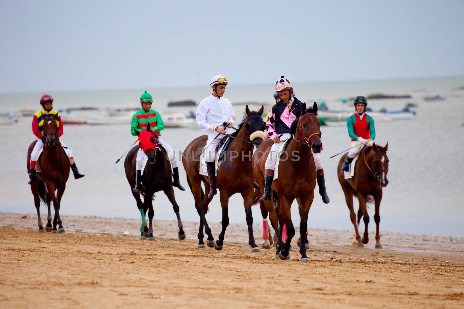 SANLUCAR DE BARRAMEDA, CADIZ, SPAIN - AUGUST 07: Unidentified riders at the start of race horses on Sanlucar de Barrameda beach on  August 07, 2010 in Sanlucar de Barrameda, Cadiz, Spain.