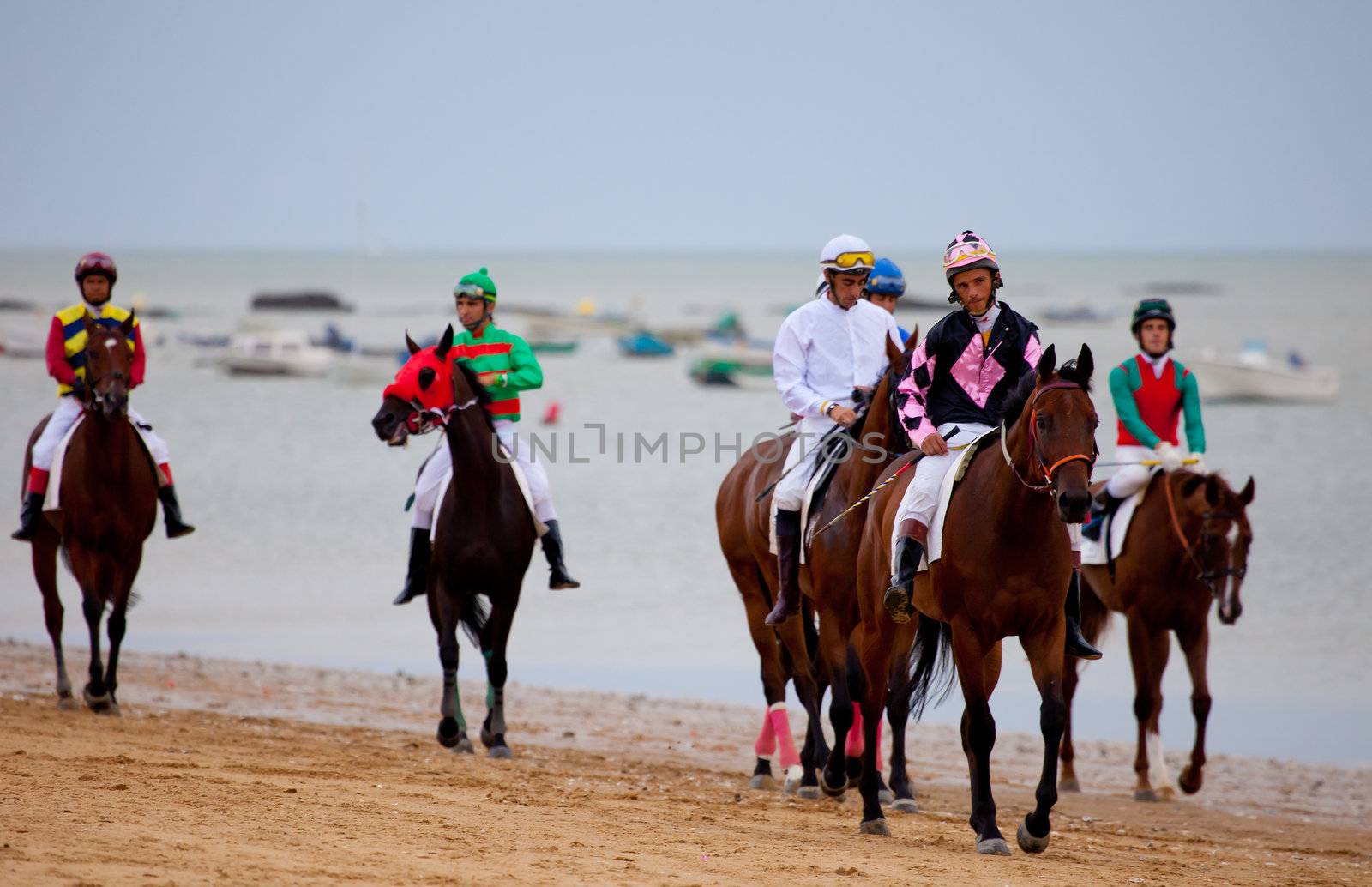 SANLUCAR DE BARRAMEDA, CADIZ, SPAIN - AUGUST 07: Unidentified riders at the start of race horses on Sanlucar de Barrameda beach on  August 07, 2010 in Sanlucar de Barrameda, Cadiz, Spain.