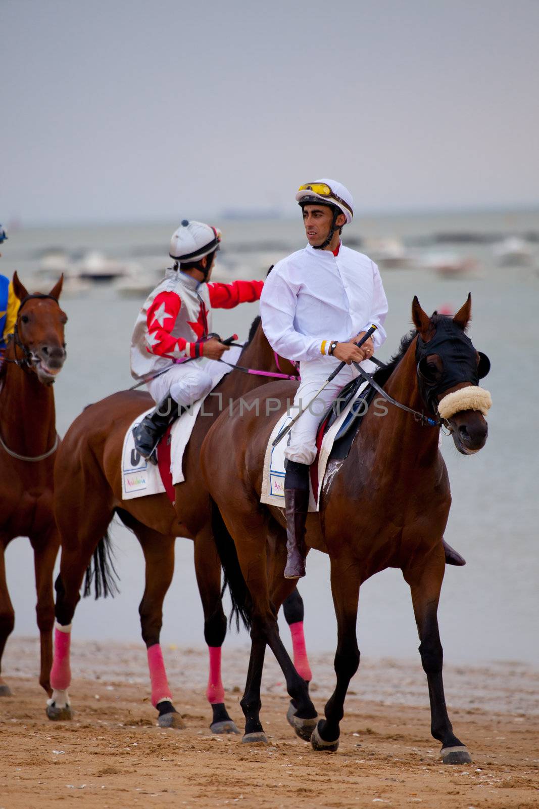 SANLUCAR DE BARRAMEDA, CADIZ, SPAIN - AUGUST 07: Unidentified riders at the start of race horses on Sanlucar de Barrameda beach on  August 07, 2010 in Sanlucar de Barrameda, Cadiz, Spain.