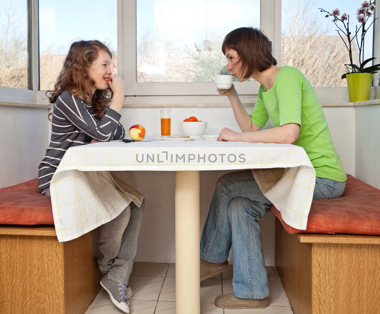 Daughter and her mom having a breakfast together.