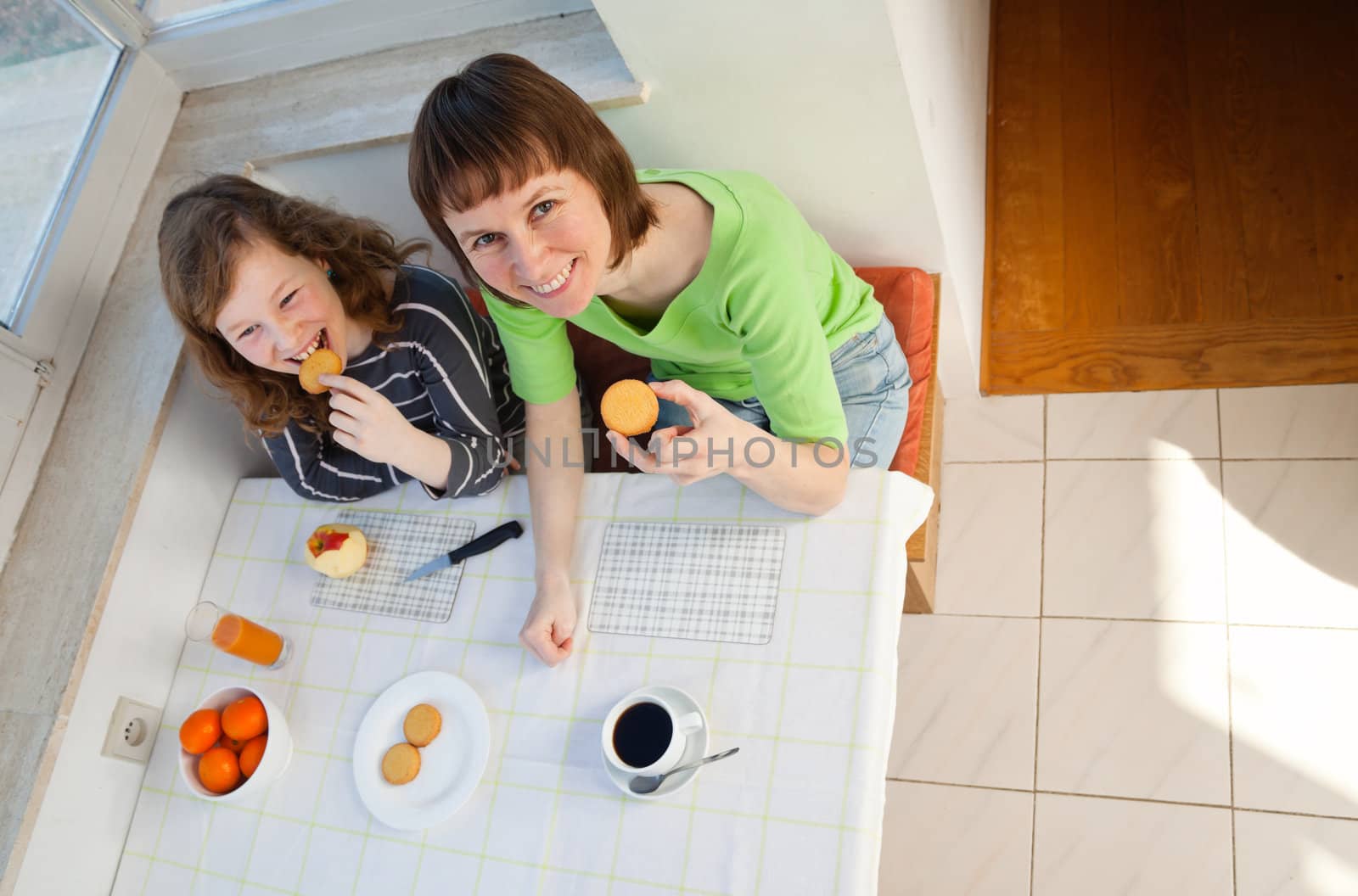 Daughter and her mom having a breakfast together. High angle view.