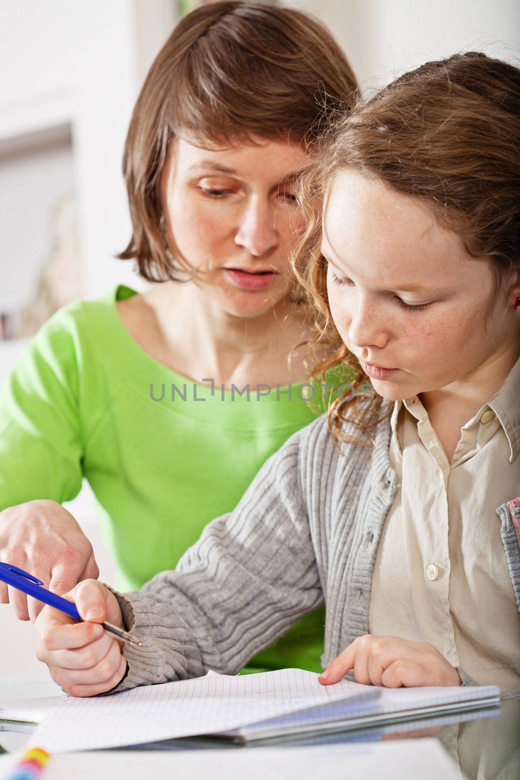 Mother helping her teenager daughter to do a homework