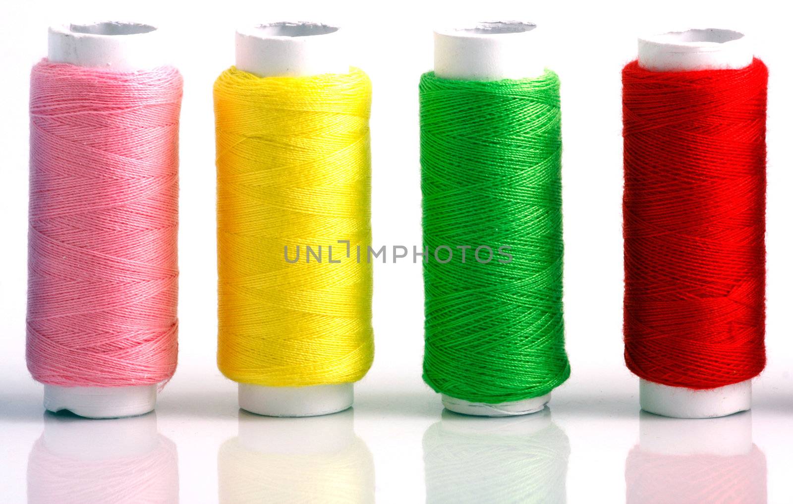Set of colorful spools of thread isolated on white background
