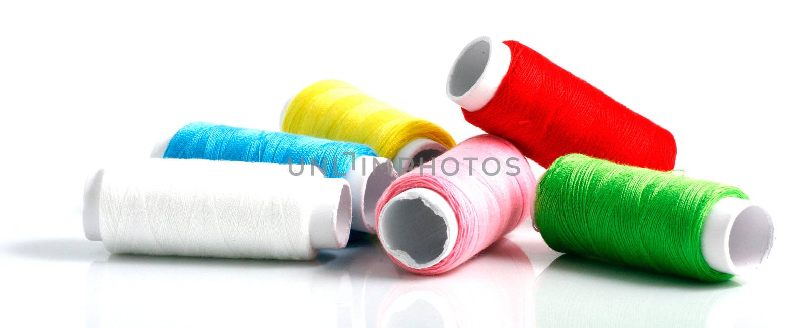 Set of colorful spools of thread isolated on white background