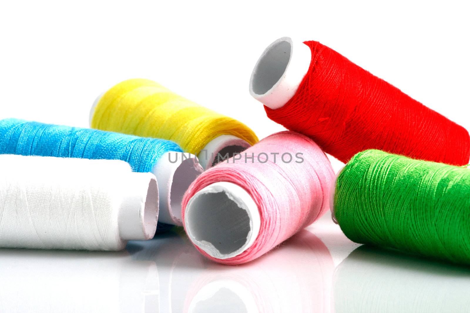 Set of colorful spools of thread isolated on white background