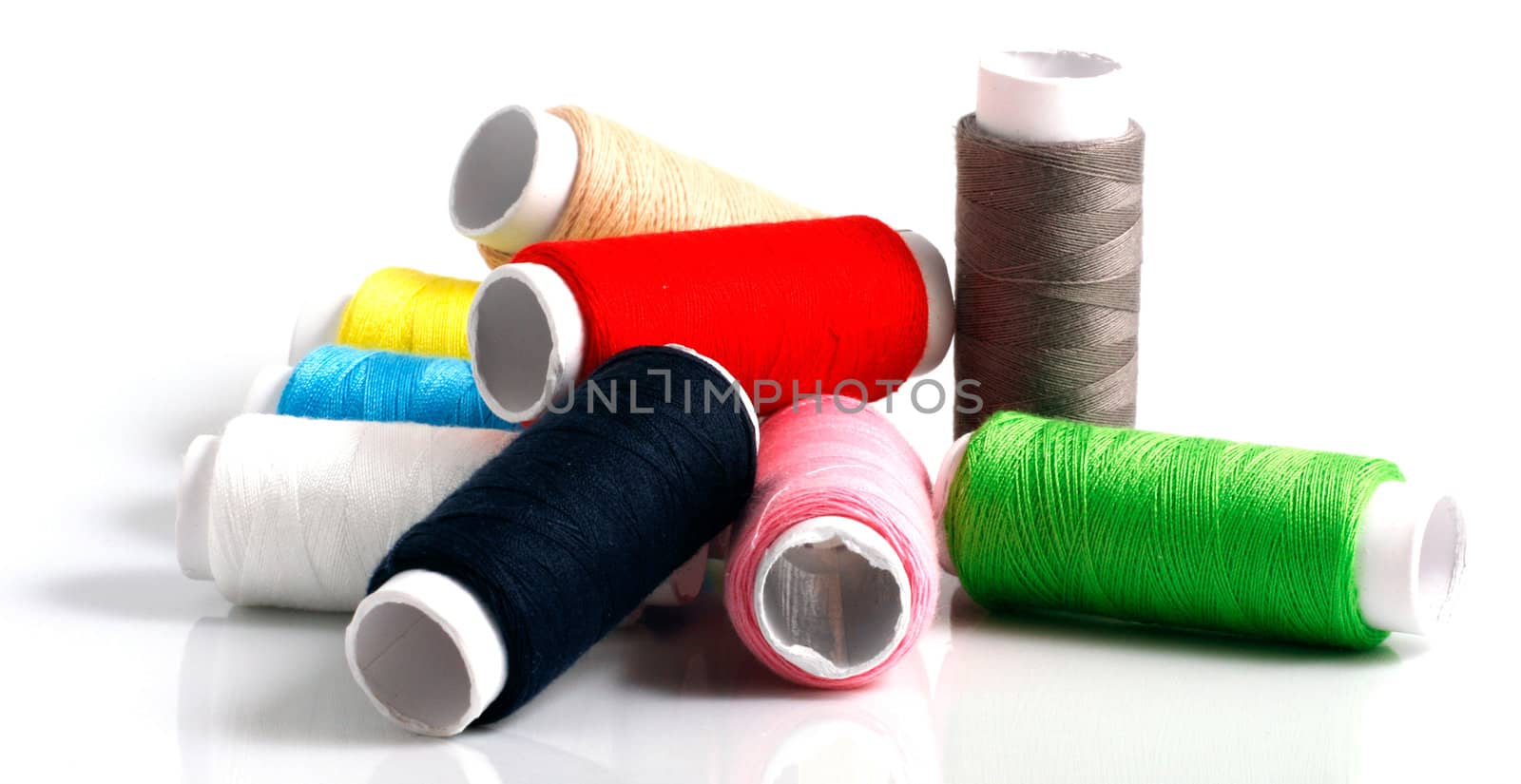 Set of colorful spools of thread isolated on white background