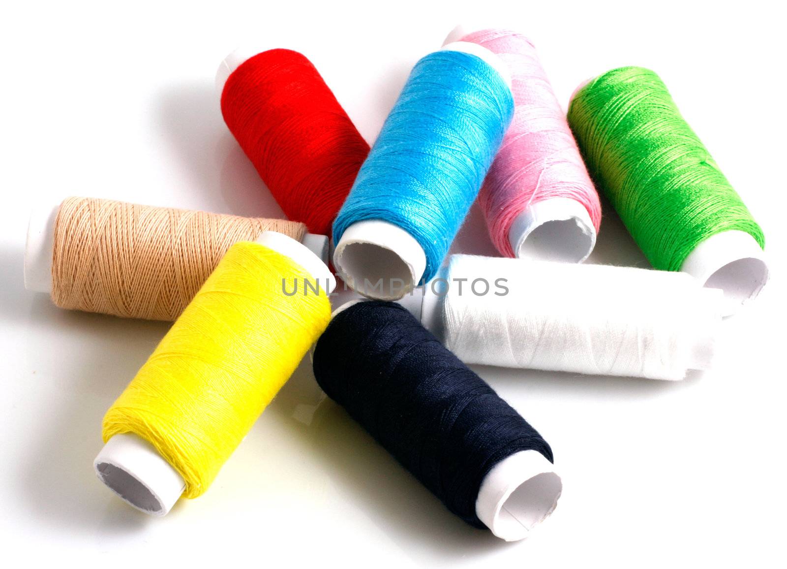 Set of colorful spools of thread isolated on white background