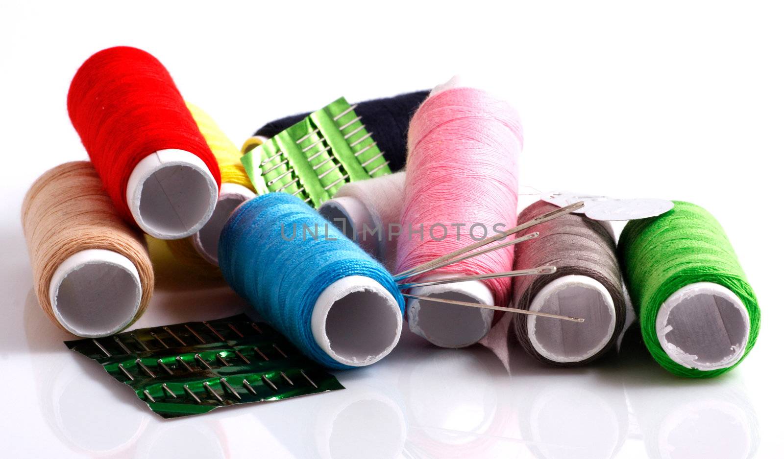Set of colorful spools of thread isolated on white background