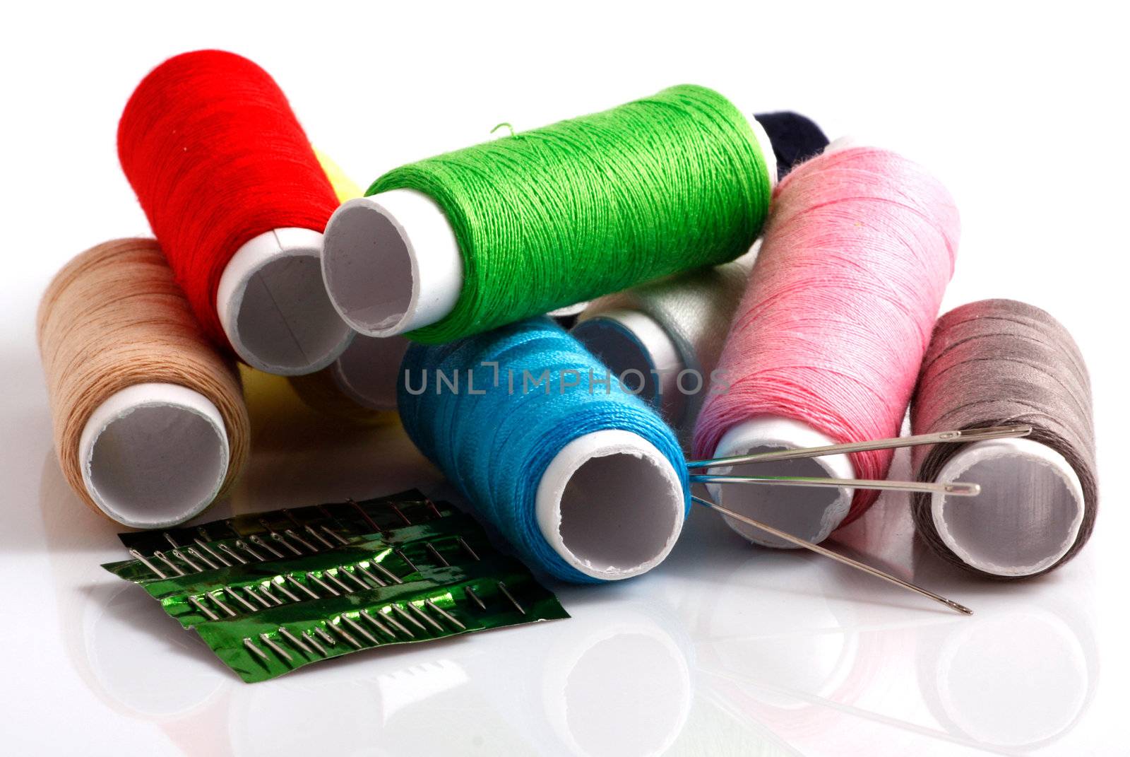 Set of colorful spools of thread isolated on white background