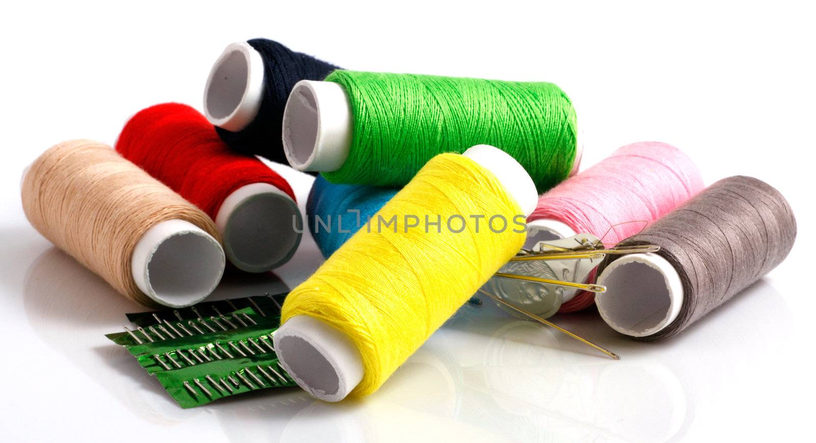 Set of colorful spools of thread isolated on white background
