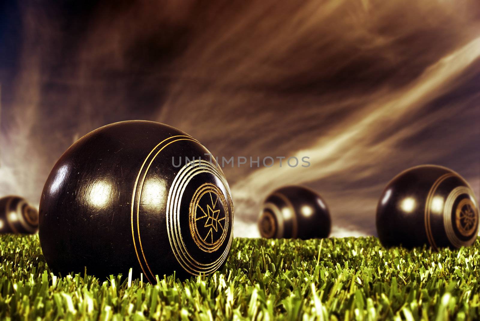 Close up of bowling balls on a bowling field at sunset by tish1