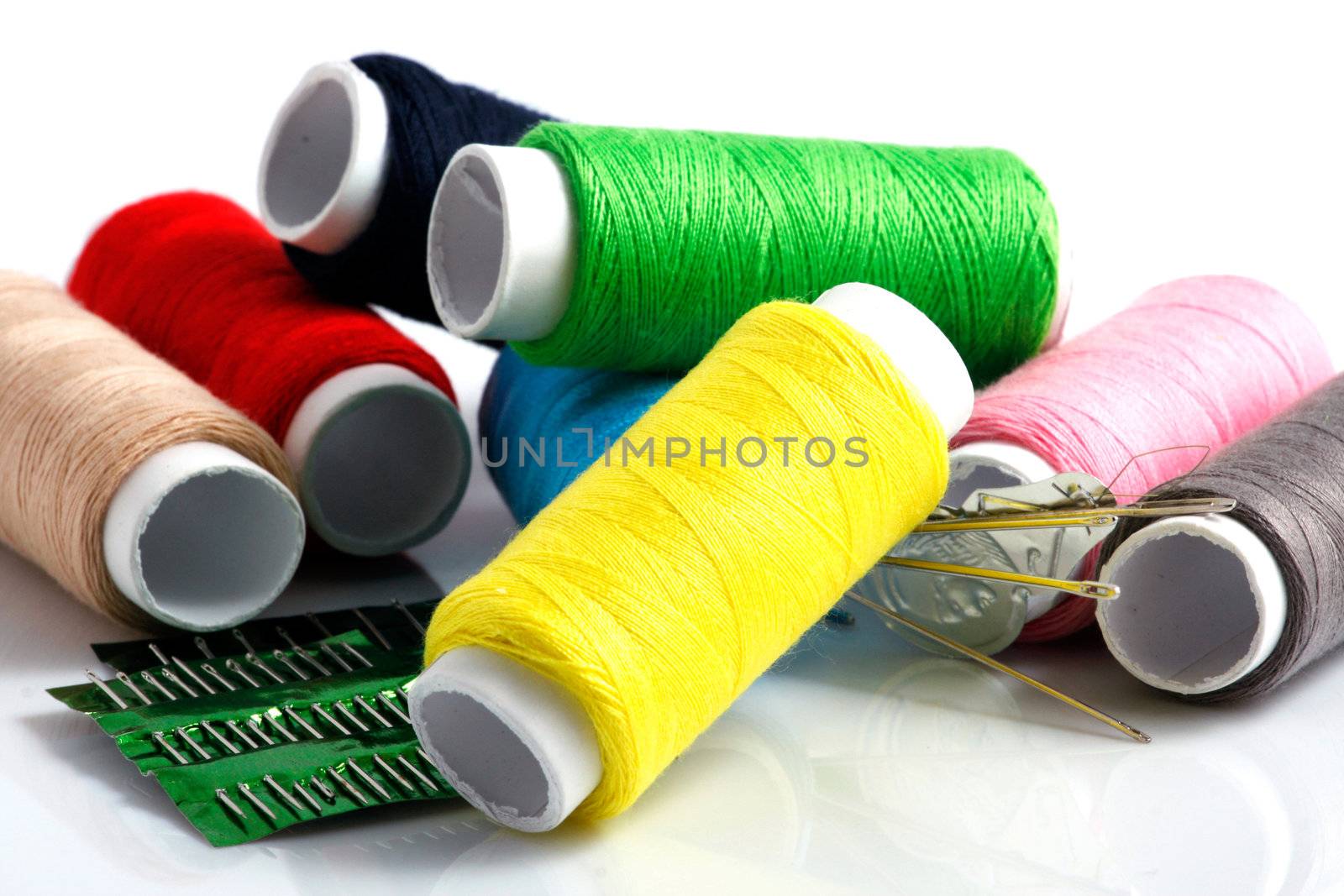 Set of colorful spools of thread isolated on white background