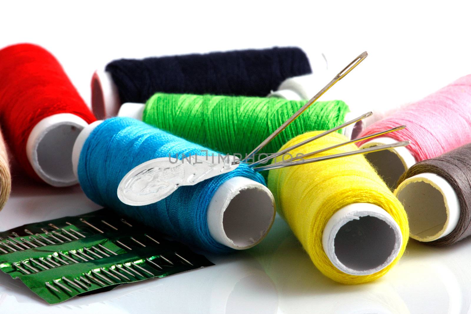 Set of colorful spools of thread isolated on white background