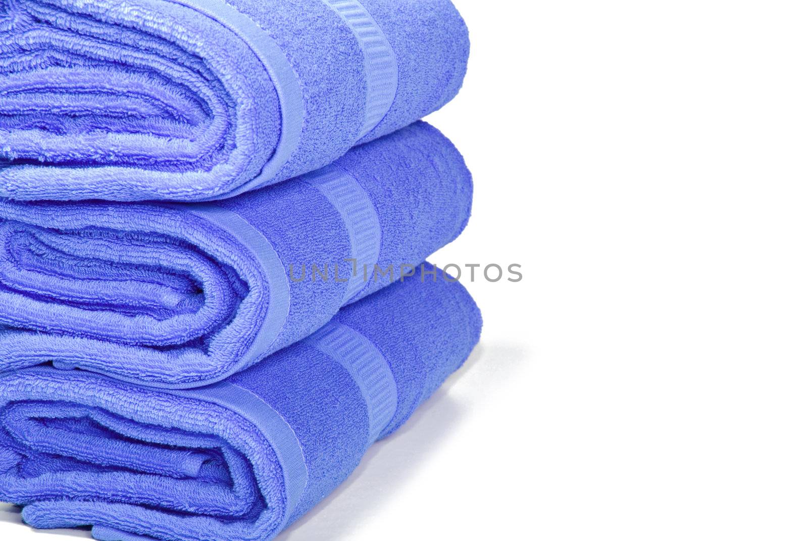 Three blue towels on a white background