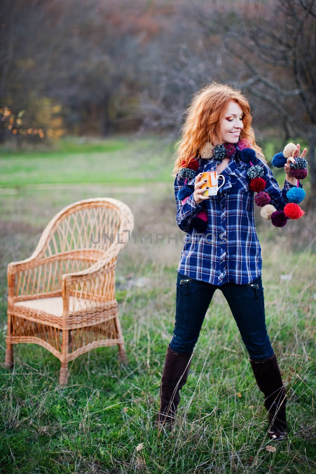 The red-haired girl in autumn leaves 
outdoor shot