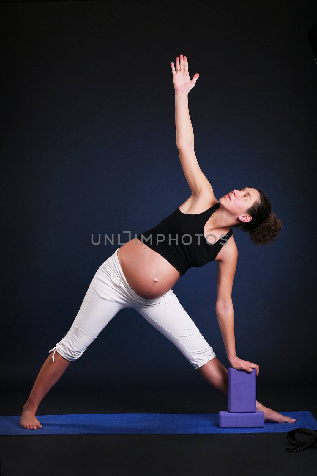 Beautiful pregnant  young woman practicing yoga by dvernytska