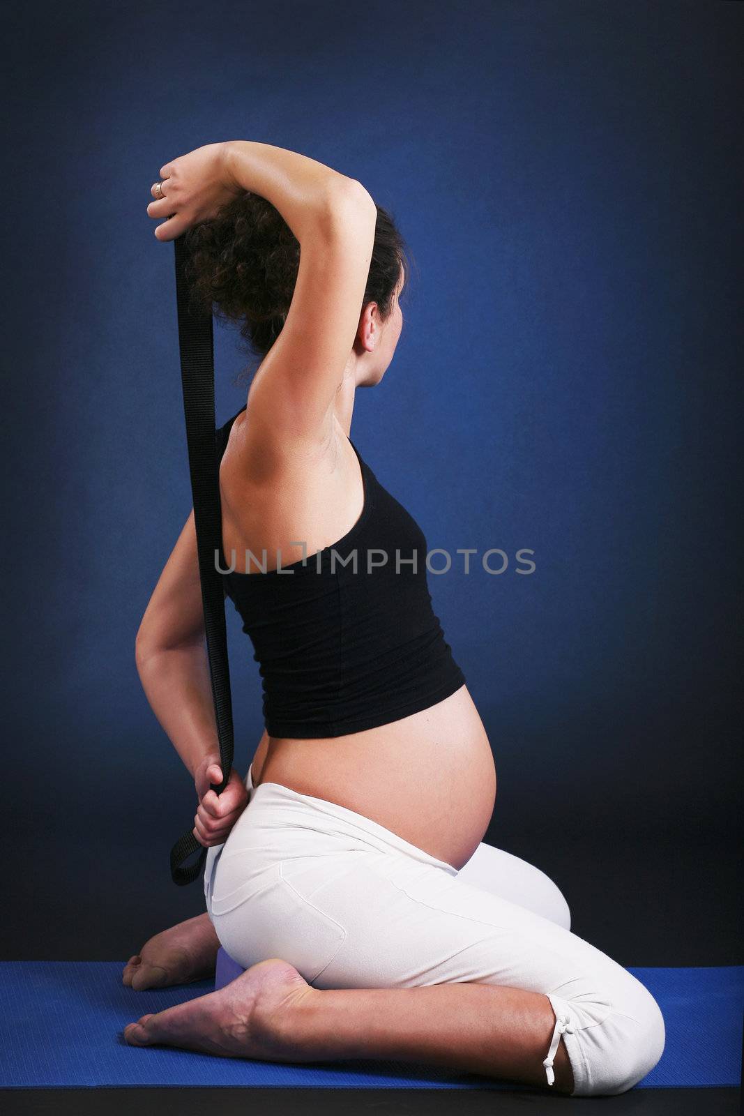 Beautiful pregnant  young woman practicing yoga by dvernytska