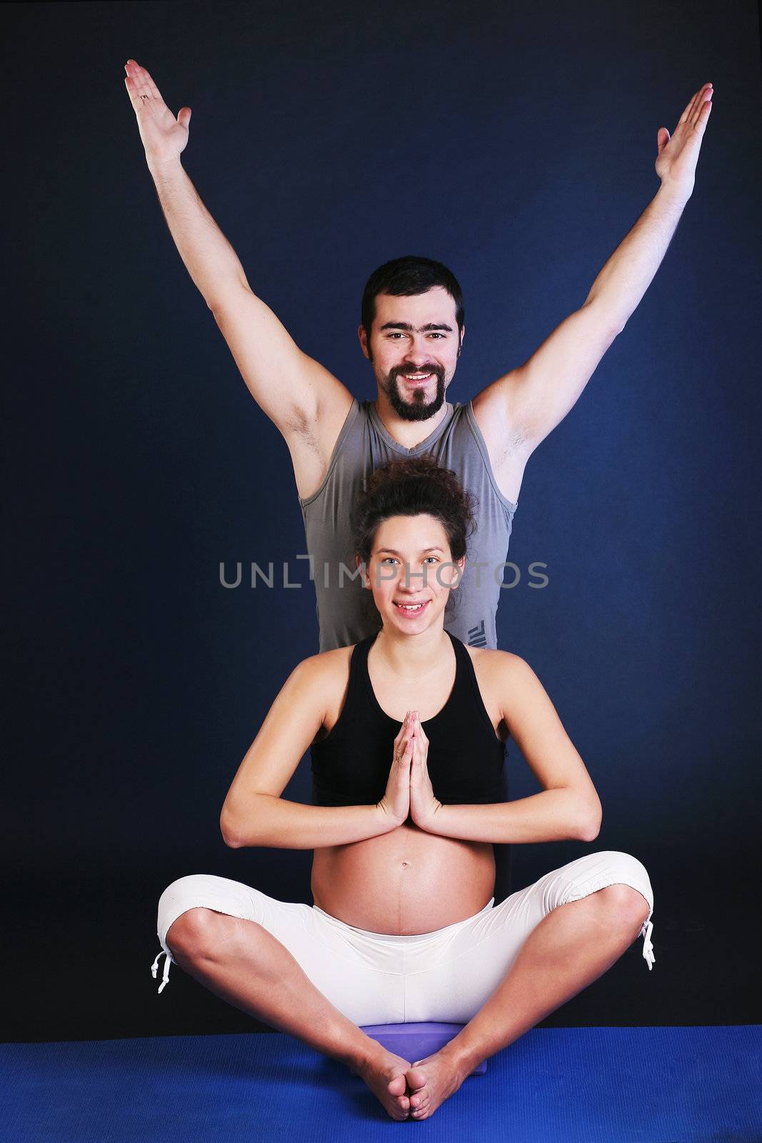 Beautiful pregnant  young woman practicing yoga by dvernytska