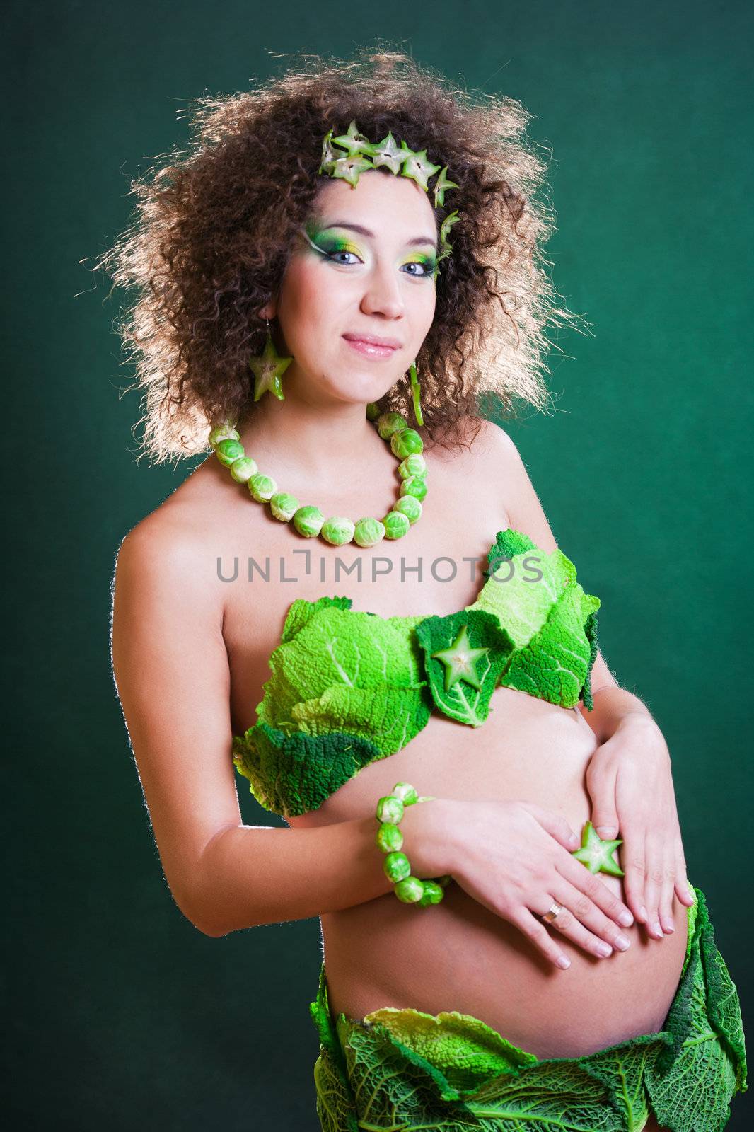 beautiful pregnant young woman dressed in cabbage